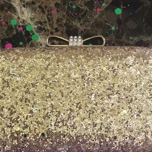 A gold glitter clutch purse